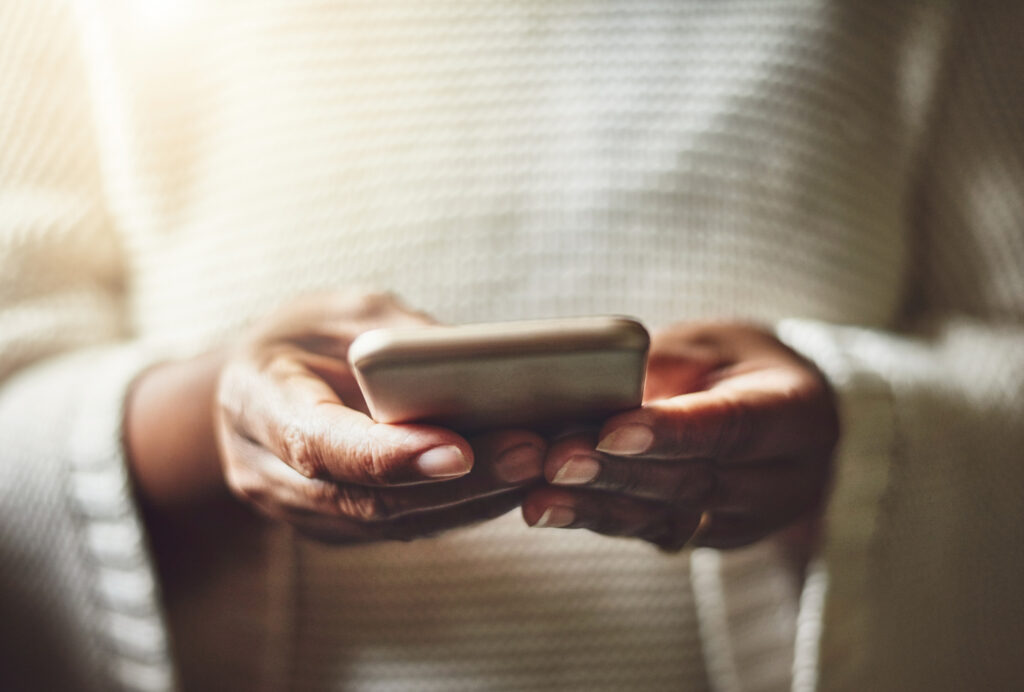 Closeup image of a woman holding a mobile phone. 